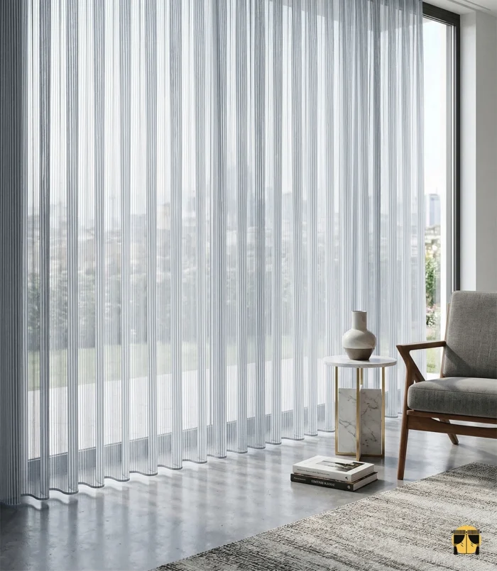 Dikey dokuma çizgilerin muntazam yapısını ve gri tonunun ipeksi dökümünü sergileyen yakın plan çekimi; kumaşın üç boyutlu derinlik katan yüzey yapısı.