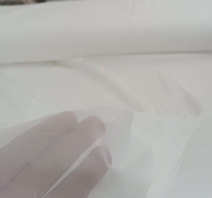 Modern salonlarda ferah ve aydınlık bir atmosfer yaratan, dökümlü ekru beyaz ipek tül perde tasarımı.