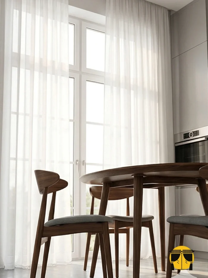 "Beyaz mutfak dolapları ve masif ahşap tezgahla dekore edilmiş modern bir mutfakta, pencerelere doğal bir derinlik katan bej krep tül tasarımı."