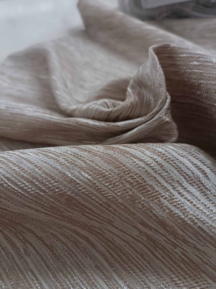 "Modern neoklasik dekorasyon anlayışına uygun, desenli yapısıyla odaya derinlik kazandıran kaliteli kum koyu bej fon perde görseli."